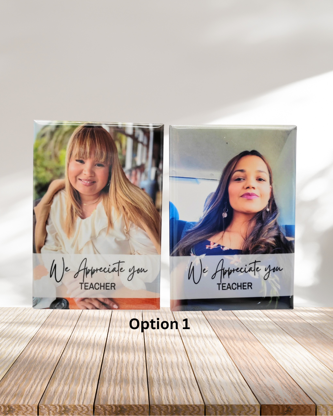 Two photo prints of a woman and a girl with 'We Appreciate you TEACHER' text on a wooden surface.
