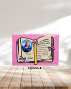 Personalized gift card with a photo of a person and text on a pink background, placed on a wooden surface.
