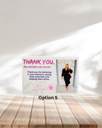 Poster with a woman in a black outfit on a wooden surface and white wall background